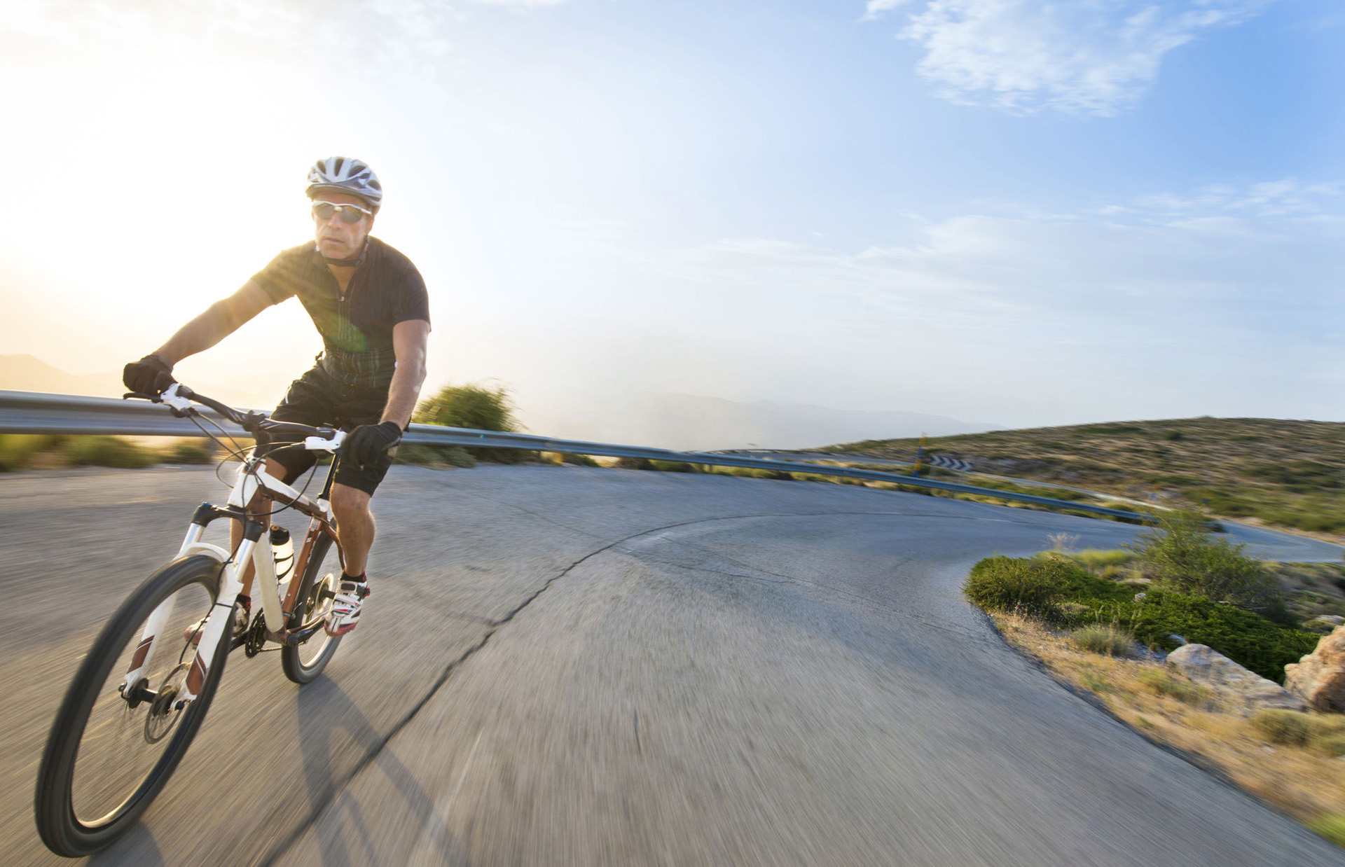 person riding bicycle on a mountain road
