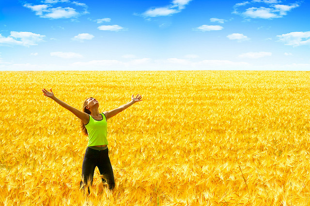 back pain, pain, low back - person with outstretched arms, in a golden field