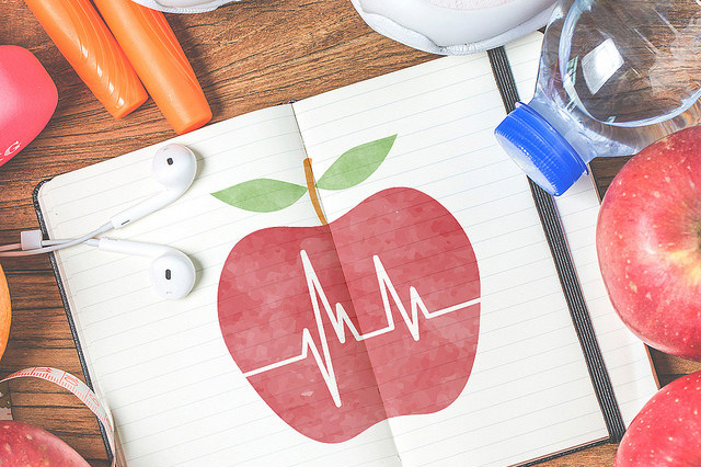 The Link between Vascular Disease and Lumbar Spine Disease - assortment of items placed around an open notebook