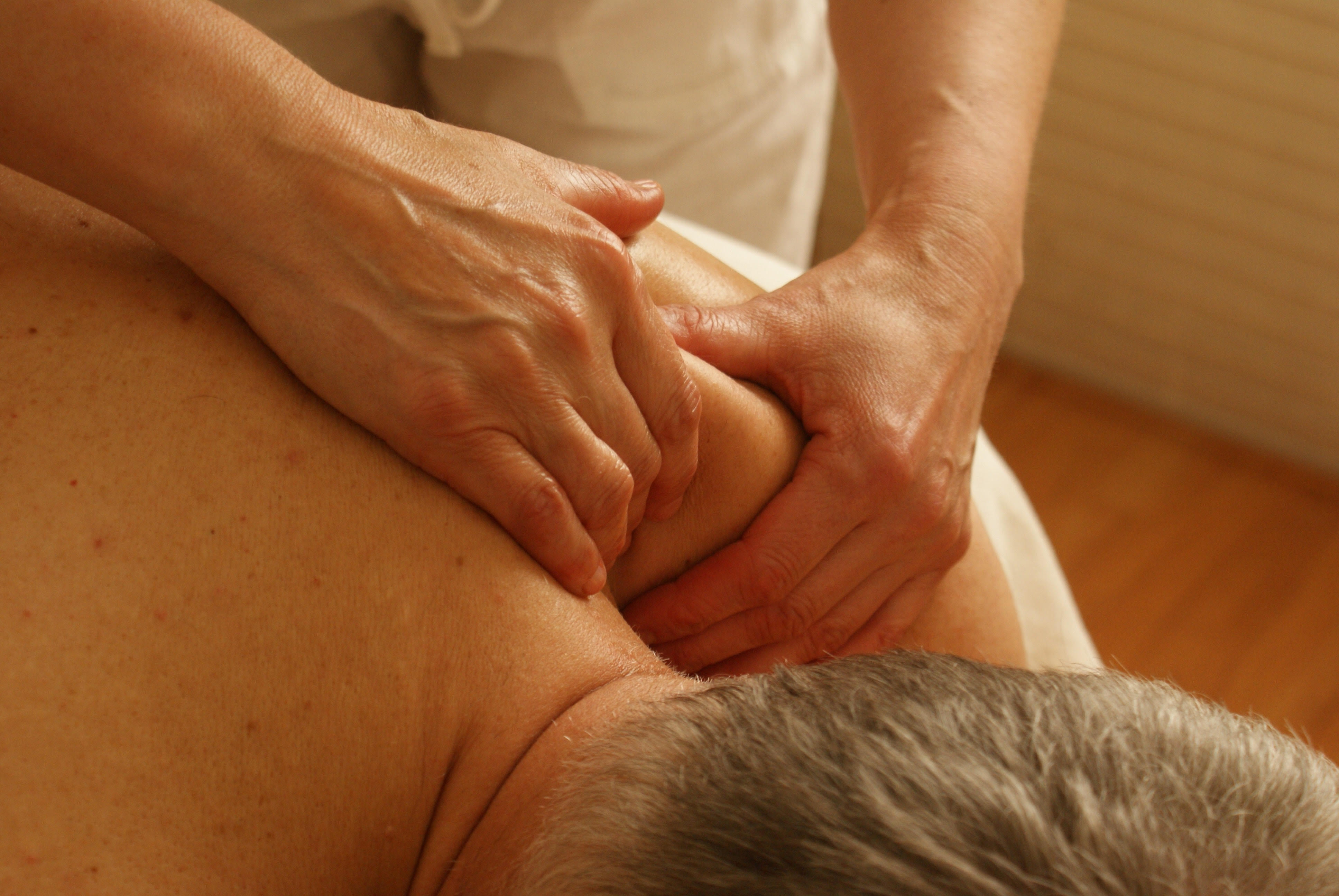Manual Therapy in Phoenix & Mesa - person massaging back-shoulder