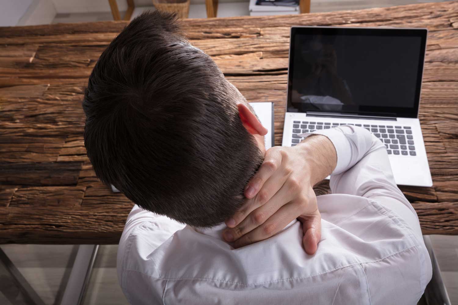 Low Back Pain in Mesa - person rubbing neck