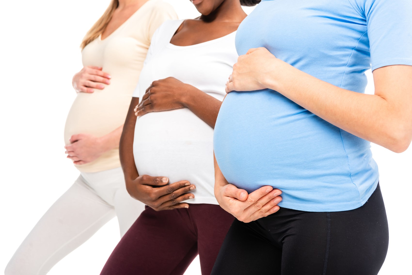 cropped view of three pregnant women holding hands on bellies - Aches and Pains in Pregnancy